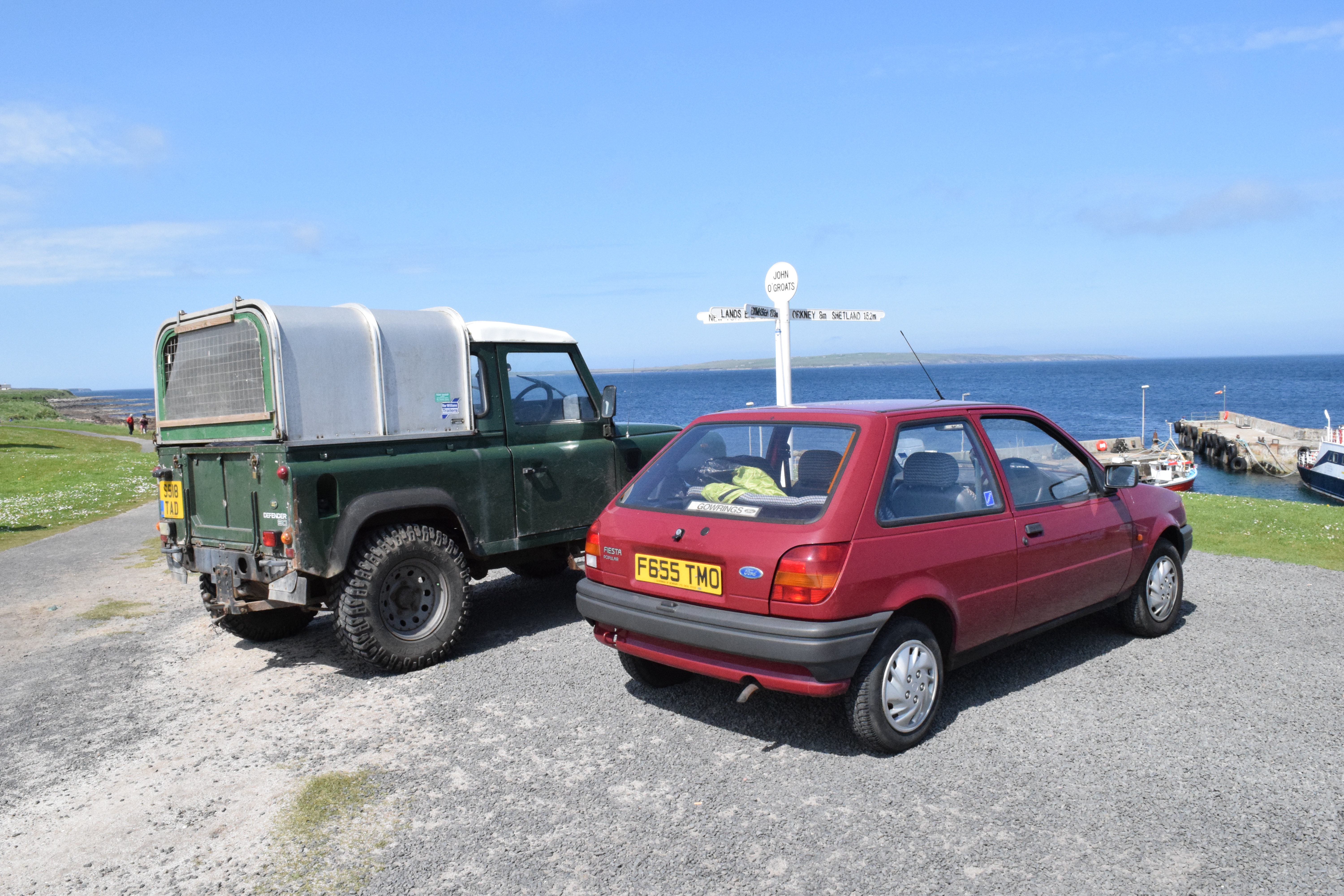 Land Rover Defender and Ford Fiesta at John O'Groats